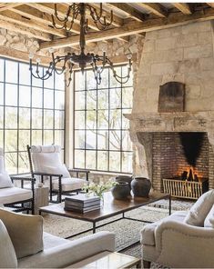 a living room filled with furniture and a fire place in the middle of a room