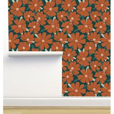 an orange and green wallpaper with flowers on it