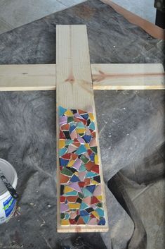 a cross made out of stained glass and wood