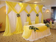 a banquet room decorated in yellow and white