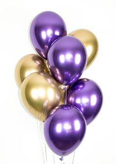 a bunch of purple and gold balloons on a white background