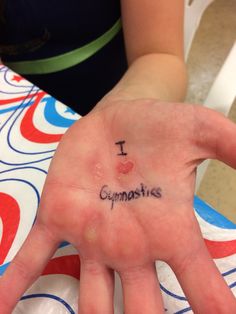 a person's hand with the word i love gymnastics written on it