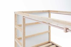 there is a wooden bunk bed frame with no mattresses on the bottom and bottom