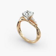 a yellow gold engagement ring with an orange and white diamond in the center, on a white background