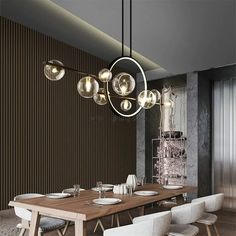 a dining room with a wooden table and white chairs next to a wall mounted chandelier