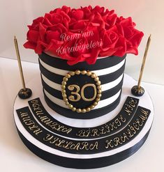 a black and white striped cake with red roses on top that reads 30th anniversary celebration