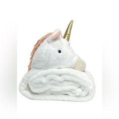 a white unicorn blanket with a gold horn on it's head and a pink nose