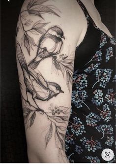 a woman's arm with a bird on the branch and leaves tattoo design in black and white