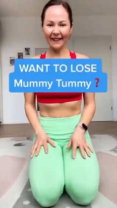 a woman sitting on the floor holding a sign that says want to lose mommy tummy?