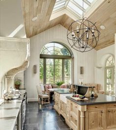 a large kitchen with an island in the middle and lots of counter space on one side