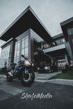 a blue motorcycle parked in front of a building