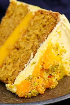 there is a piece of cake with white frosting on the top and yellow icing on the bottom