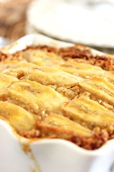 a casserole dish with meat and cheese in it sitting on a wooden table