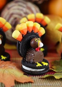 a turkey made out of oreo cookies sitting on top of a leaf covered table