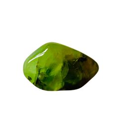 a large green rock sitting on top of a white surface