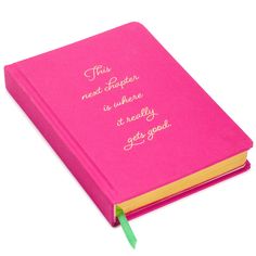 a pink book with writing on it