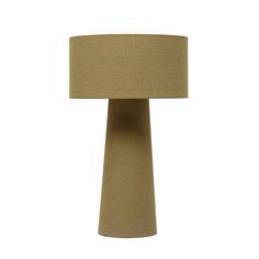 a lamp that is on top of a white surface with a beige shade over it