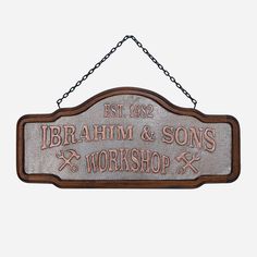 a wooden sign hanging from the side of a building that says, brahim & sons workshop