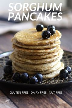 a stack of pancakes with blueberries on top and the words sorghum pancakes above it