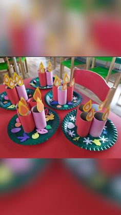 paper plates with lit candles on them sitting on a table