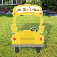 a yellow school bus with the words mrs sun's class on it in front of a house