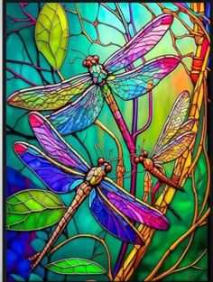 three dragonflies sitting on top of a tree branch in front of a stained glass window