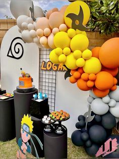 an assortment of balloons and decorations on display at a cartoon themed birthday party or baby shower