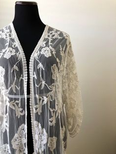 "This overlayering piece is made with soft embroidered sheer lace, features mid sleeve with scalloped sleeve edge and hem. Makes for a super sweet cover up for any outfit! ONE SIZE FITS MOST - SMALL, MEDIUM, LARGE Length: 37\" Bust: 23\" (open front, one size fits all) Armhole: 11\" Now when you order two items or more, your shipping is on us! Enter FREESHIP at checkout! ( US shipping only) And/Or Share your photo with me in the item you purchased, you will receive a $15 coupon toward your next Wedding Kimono With Floral Embroidery, Bohemian Floral Embroidered Open Front Kimono, Bohemian Open Front Kimono With Floral Embroidery, Fitted Lace Cover-up With Lace Trim, Spring Wedding Embroidered Kimono, Spring Wedding Kimono With Floral Embroidery, Bohemian Long Sleeve Embroidered Cover-up, Bohemian Long Sleeve Kimono With Chikankari Embroidery, Sheer Long Sleeve Festival Cover-up