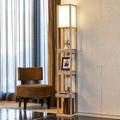 a living room filled with furniture and a tall book shelf next to a window covered in curtains