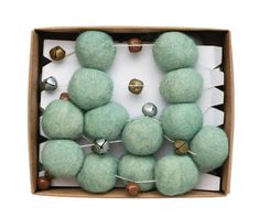 a box filled with green balls and bells