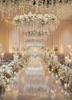 the aisle is decorated with white flowers and candles for an elegant wedding ceremony at the four seasons hotel