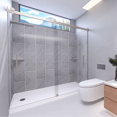 a bathroom with a toilet, shower and sink in it's center wall is shown