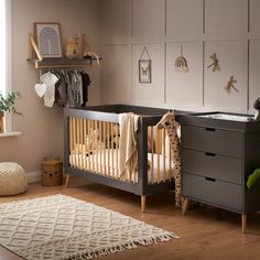 a baby's room with a crib and dresser