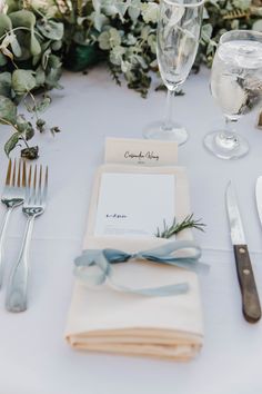 the table is set with silverware, napkins and place settings for an event