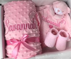 a pink baby gift set in a box with its matching booties and mitts