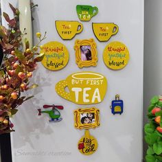 a refrigerator with magnets on the front and side of it that says, but first tea