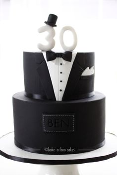 a black and white cake with the number 30 on it