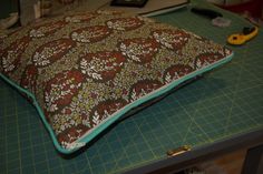 a pillow sitting on top of a cutting board