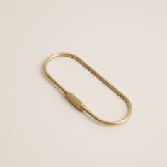 a gold paperclip on a white background