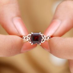 Product Details Embrace yourself with the captivating beauty of this Solitaire Ring adorned with an 8 MM Asscher Cut Garnet gemstone and Celtic Design. Product Information SKU SHP-RINGS0821135750 Width 7 mm Height 5 mm Weight 2.48 gm (Approximate) GARNET INFORMATION No.of Stones 1 Pieces Total Weight 3.30 Carat (Approximate) Dimension(approx) Asscher-8X8 mm-1 Pcs Color Red Cut Brilliant Shape Asscher Setting Type Other-Setting Quality Grade AAA View More Product Parent Collection Handle garnet-rings Garnet Stone Ring, Embrace Yourself, Celtic Ring, Celtic Design, Celtic Rings, Asscher Cut, 18k Yellow Gold Ring, Garnet Stone, Signature Jewelry