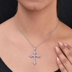 Inspired by cross theme, this pink CZ cross pendant necklace displays a captivating charm. Cross symbolizes faith in Christianity. Laced with dazzling white CZ, this 20-inch matinee pendant necklace features pink CZ rounds with sparkling brilliance. Set in surgical grade stainless steel, this jewelry piece will make you sparkle for the right reason. CZ is the best man made alternative for diamonds. With 8- 8.5 rank on the Mohs scale of hardness, CZ is perfect for daily wear. Lead and Nickel Free Pink Cross-shaped Jewelry For Gift, Pink Cross-shaped Jewelry Gift, Pink Cross Pendant Jewelry As Gift, Pink Cross Pendant Necklace For Gift, Pink Cross Necklace For Gifts, Pink Cross Necklace For Gift, Pink Sterling Silver Cross Jewelry, Pink Cross Sterling Silver Jewelry, Necklace Displays