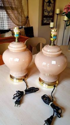 two pink lamps sitting on top of a table