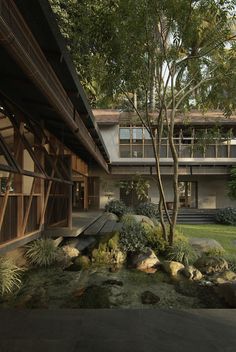 an exterior view of a house with trees and rocks