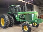 a large green tractor parked in a garage