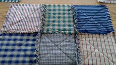 four different plaid fabric squares laid out on the floor