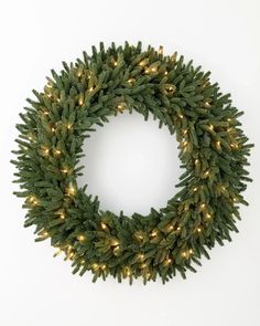 a christmas wreath with lights hanging from it