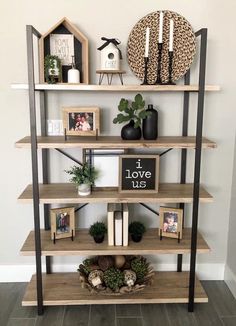 a shelf with some pictures and plants on it