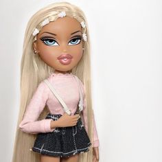 a doll with long blonde hair wearing a pink sweater and black skirt, holding a white purse