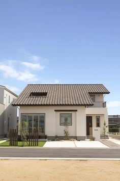 a white house with a brown tiled roof