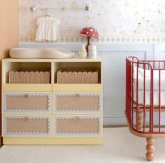 a baby's room with a crib, dresser and changing table in it